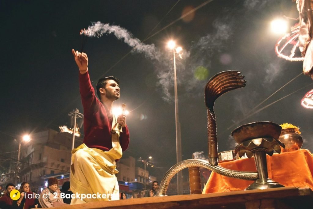 The priests hold incense sticks in one hand and prayer bells on the other during the Ganga Aarti at Varanasi