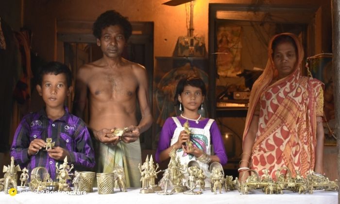 A family displaying their Dokra handicraft during the Dokra annual fair